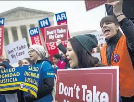  ?? Jim Lo Scalzo European Pressphoto Agency ?? SUPPORTERS of the Affordable Care Act rally outside the Supreme Court, which heard a challenge brought by conservati­ve and libertaria­n activists.