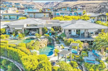  ?? Keller Williams Southern Nevada ?? The new leader for Las Vegas listings came out at $18 million in the spring of 2021 but was bumped up to $24.8 million earlier this year. The Macdonald Highlands home on Boulder Summit Drive sits on 2 acres and overlooks Dragon Ridge Country Club.