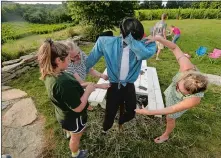  ?? DANA JENSEN/THE DAY ?? Sophia Raposa, 15, left, her mother, Christine Raposa, second from left, and friend Marie Healy, right, all of Griswold, work on their Michael Jackson scarecrow during the scarecrow-building workshop at the Preston Ridge Vineyard on Sept. 5 in advance of the annual Scarecrow Festival on Sept. 22.