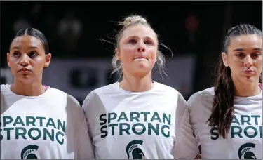  ?? Associated Press ?? Emotional moment: Michigan State players Moira Joiner, left, Theryn Hallock, center, and Abbey Kimball stand together before an NCAA college basketball game against Maryland, Saturday in East Lansing, Mich.
