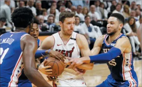  ?? THE ASSOCIATED PRESS FILE ?? Sixers guard Ben Simmons, right, had his share of slaps and shoves with Miami Heat guard Goran Dragic, center, during the Sixers’ five-game victory over the Heat in the first round.