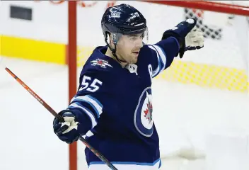  ?? JOHN WOODS/ THE CANADIAN PRESS ?? Winnipeg Jets’ Mark Scheifele celebrates his game-winning overtime goal in Sunday’s 5-4 victory over the Tampa Bay Lightning. Nobody’s been hotter of late than Scheifele with eight goals in his last nine games, giving him 21 on the season.