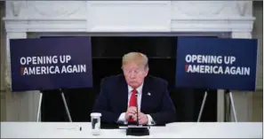  ?? (AFP) ?? US President Donald Trump takes part in a roundtable discussion with industry executives on reopening the country, in the State Dining Room of the White House in Washington on Friday.