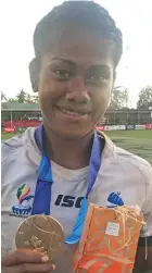  ??  ?? Team Fiji women’s 7s rep Tokasa Seniyasi shows her gold medal at the Pacific Games in Apia, Samoa on July 13, 2019.
Photo: Anasilini Natoga