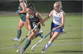  ?? ?? Wachusett's Lindsey McGurl and Leominster's Taylor Boulay battle for possesion during Monday night's field hockey game at Doyle Field in Leominster.