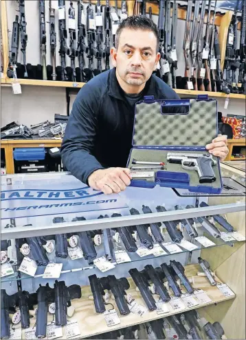  ?? [FRED SQUILLANTE/DISPATCH] ?? Eric Delbert, co-owner of L.E.P.D. Firing Range on the Northwest Side, says he has no way of knowing whether a gun being sold to him is stolen. He’d like to see gun shop owners have access to a database that would allow a check of a firearm’s origin.