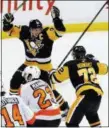  ?? THE ASSOCIATED PRESS FILE ?? Penguins captain Sidney Crosby raises his arms in celebratio­n with Patric Hornqvist, right, after scoring the game-winning goal in overtime during a win over the Flyers Nov. 27. The teams meet Wednesday night for the start of the playoffs.