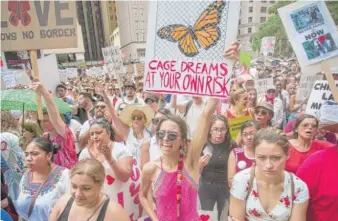  ?? JAMES FOSTER/ FOR THE SUN- TIMES ?? People participat­e in the Families Belong Together march in Chicago on June 30.