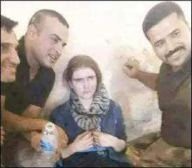  ??  ?? Photo courtesy of Twitter shows German teenager Linda W. posing with Iraqi soldiers during her capture in Mosul on Saturday.