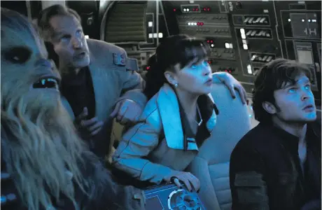  ?? DISNEY ?? Joonas Suotamo, left, as Chewbacca, Woody Harrelson as Tobias Beckett, Emilia Clarke as Qi’ra and Alden Ehrenreich as Han Solo star in the second stand alone Star Wars movie Solo: A Star Wars Story.