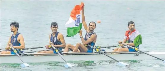  ?? PTI ?? ▪ Indian quadruple sculls team (from left) Sawarn Singh, Bhokanal Dattu, Om Prakash and Sukhmeet Singh with the Tricolour after winning the gold medal at the Asian Games on Friday.