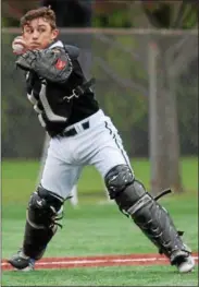  ?? RANDY MEYERS — THE MORNING JOURNAL ?? Elyria Catholic catcher Grant McClure picks up a Bay bunt and throws to first for the out on May 2at Oberlin College.