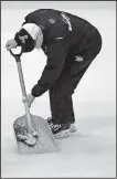  ?? AP/GENE J. PUSKAR ?? An ice worker removes a dead catfish tossed by spectator Jacob Waddell during Game 1 of the Stanley Cup Final on Monday night in Pittsburgh. Waddell, who was ejected, is facing criminal charges.