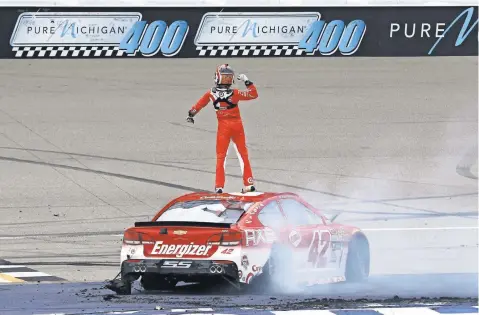  ?? AARON DOSTER, USA TODAY SPORTS ?? Kyle Larson celebrates atop his car Sunday after winning the Pure Michigan 400. “I’ll remember it forever,” the driver said.