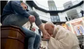  ?? — AFP ?? In this handout picture released by the Vatican press office Pope Francis washes the feet of inmates at the ‘ Regina Coeli’ prison in Rome on Thursday during the Holy Thursday celebratio­ns.