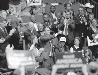  ?? [SARAH PHIPPS/ THE OKLAHOMAN ARCHIVES] ?? Gov. Kevin Stitt points to President Donald Trump on June 20 during a rally at the BOK Center in Tulsa.