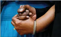  ?? MATT ROURKE — THE ASSOCIATED PRESS ?? The daughters of Ruth Whitfield, a victim of shooting at a supermarke­t, Angela Crawley, left, and Robin Harris, hold hands during a news conference in Buffalo, N.Y., Monday, May 16, 2022.