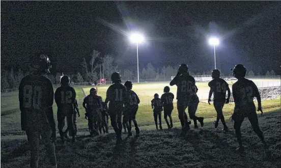  ?? PHOTOS BY CURTIS COMPTON / CCOMPTON@AJC.COM ?? In November 2009, the Greenville Patriots take the field at home for their playoff against Pelham before the lights went out at halftime, delaying the game before the Patriots eventually won 25-0. With that victory, Greenville managed to string...