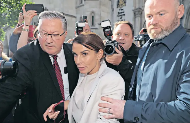  ?? ?? Coleen and Wayne Rooney leave the High Court in London, after Mrs Rooney’s first day of giving evidence in the libel trial between her and Rebekah Vardy