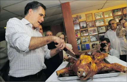  ??  ?? EMMANUEL DUNAND/AFP/GETTY Images Republican presidenti­al hopeful Mitt Romney cuts a roast pig as he meets with voters at Casa Marin
restaurant in Hialeah, Fla., on Sunday. Florida will hold its Republican primary on Tuesday.