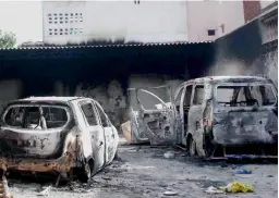  ?? — PTI ?? Vehicles damaged in a fire after a clash between two communitie­s at Atali village in Faridabad on Tuesday.