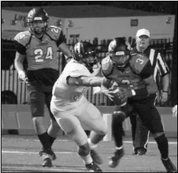  ?? Photo by Alexis Meeks ?? Malvern quarterbac­k Cedric Simmons escapes an Ashdown defender during last week’s game. Simmons once again was a force on offense throwing for 228 yards and four touchdowns.