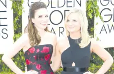  ?? — AFP file photos ?? This January 12, 2014 photo shows actress Tina Fey (left) and Amy Poehler arriving for the 71st Golden Globe Awards held at the Beverly Hilton hotel in Beverly Hills.