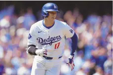  ?? ASSOCIATED PRESS ?? The Los Angeles Dodgers’ Shohei Ohtani runs to first base after hitting a double against the St. Louis Cardinals during the first inning of Thursday’s season opener in Los Angeles.