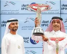  ??  ?? From left: Abdul Rahman Al Mansour receives the trophy on behalf of the owner Shaikh Mohammad Bin Khalifah Al Thani from Suhail Al Mazroeui, Managaing Director at IPIC, after Reda won the Dubai Kahayla Classic. Trainer Julian Smart is elated after claiming the lone Purebred Arabian race of the showpiece while Al Mazroeui honours jockey Harry Bentley for his winning effort.