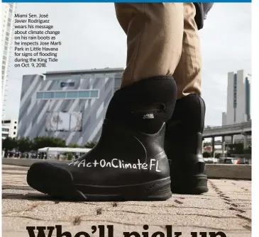  ??  ?? Miami Sen. José
Javier Rodríguez wears his message about climate change on his rain boots as he inspects Jose Marti Park in Little Havana for signs of flooding during the King Tide on Oct. 9, 2018.