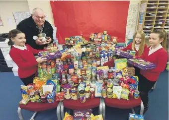  ??  ?? Brian Wilson of the East Durham Trust collecting food donated by pupils at South Hetton Primary School.