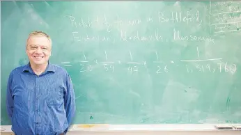  ?? BRANDON HARDER ?? Andrei Volodin, a professor of statistics at the University of Regina, stands next to an equation on the blackboard in his office. The equation relates to the probabilit­y of Prairie Sky Cannabis winning a cannabis retail licence in four different...