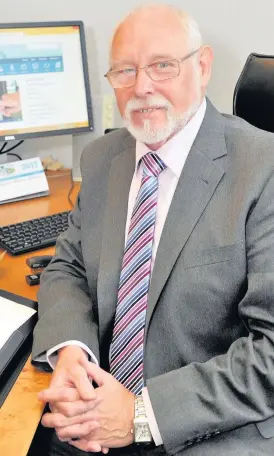  ??  ?? In control Council leader John Ross at his desk