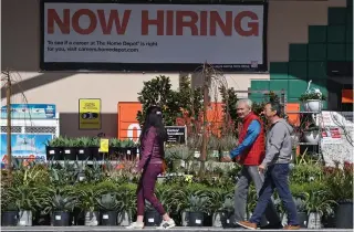  ?? NORTH AMERICA / Getty Images via AFP Photo by JUSTIN SULLIVAN / GETTY IMAGES ?? Home Depot customers walk by a posted now hiring sign on March 08, 2024 in San Rafael, California.