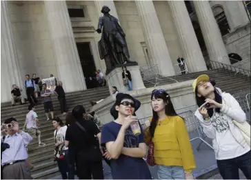  ??  ?? Lucrative market: A file picture showing a group of tourists from China in New York. The number of visitors from China dropped nearly 4% in the first half of this year after a 6% drop lastyear.—ap