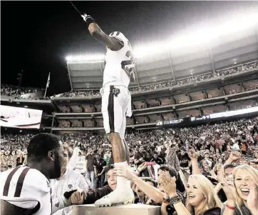  ?? Karen Warren / Houston Chronicle ?? Texas A&M defensive back Dustin Harris knows how to stand out in a crowd while celebratin­g last November’s 29-24 win over No. 1 Alabama. The Crimson Tide’s fandom hopes the result isn’t repeated Saturday.