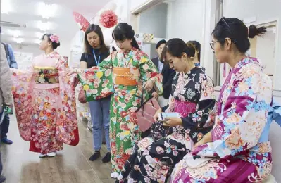  ??  ?? Geishas in waiting: Xymax business developmen­t officer Karen Barretto (in black top) mingles with the “geishas’’ at Yumeyakata in Kyoto where you can buy or rent the Japanese national costume for a day.
