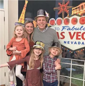  ?? COURTESY PHOTO ?? Abby Adair Reinhard, her husband, Josh, and their three children pose for a family photo during a celebratio­n at home where they pretended to travel to Las Vegas.