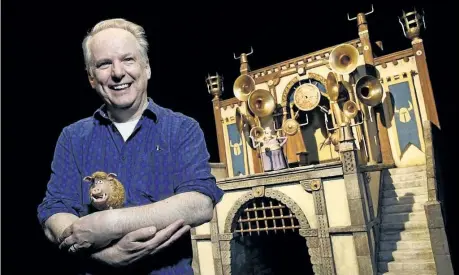  ?? CHRIS PIZZELLO/INVISION/AP ?? Nick Park, director of the stop-motion animated film Early Man, and the voice of the wild boar character Hognob, cradles the puppet as he poses in front of the film’s Royal Box set at the Beverly Hilton in Beverly Hills, Calif.