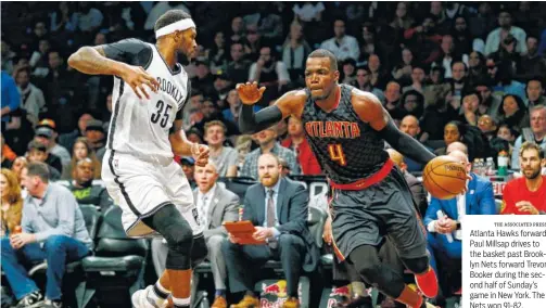  ?? THE ASSOCIATED PRESS ?? Atlanta Hawks forward Paul Millsap drives to the basket past Brooklyn Nets forward Trevor Booker during the second half of Sunday’s game in New York. The Nets won 91-82.