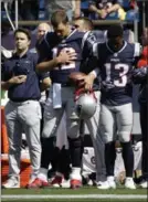  ?? STEVEN SENNE, THE ASSOCIATED PRESS ?? New England Patriots quarterbac­k Tom Brady (12) links arms with Phillip Dorsett (13) before Sunday’s game in Foxborough, Mass.