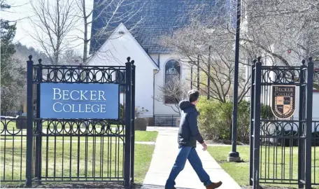  ?? CHRIS CHRISTO PHOTOS / HERALD STAFF ?? COLLEGE CLOSING: A pedestrian passes gates on the Becker College campus in Worcester. Below, the college’s admissions office on Sever Street in Worcester. The school also has a campus in Leicester.