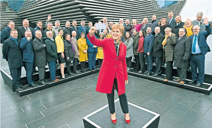  ??  ?? First Minister Nicola Sturgeon poses with the SNP’s newly elected MPs at a photocall outside the V&A Museum in Dundee