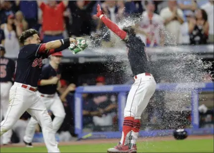  ?? TONY DEJAK — THE ASSOCIATED PRESS ?? The Indians’ Giovanny Urshela douses teammate Francisco Lindor after Lindor hit a walkoff home run in the 10th inning.