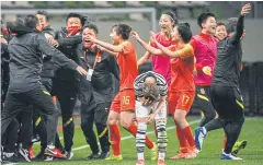  ?? AFP ?? China players and officials celebrate after the match against South Korea.