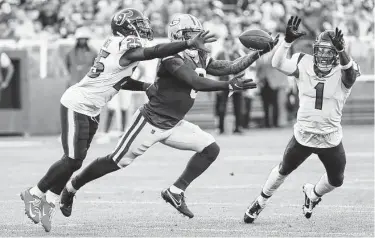  ?? Brett Coomer / Staff photograph­er ?? Texans defensive back Desmond King II, left, and cornerback Lonnie Johnson break up a pass during the first quarter. Both players got the start in Lovie Smtih’s new defense, at safety and slot corner, respective­ly.