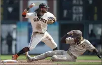  ??  ?? The Padres’ Fernando Tatis Jr. is forced out at second base by the Giants’ Brandon Crawford in the fifth inning on Thursday.