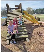  ??  ?? The playground was also part of the purchase of the old Baptist camp, as was the pool in the background. Childers said they were unsure yet if the pool was feasible or if the plumbing worked properly. Shown are the Childerses’ younger three daughters, from left, Addie, 11, Lilla, 8, and Millie Jo, 2.