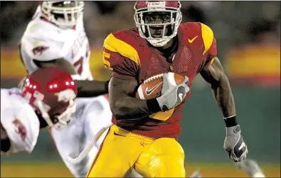  ?? Democrat-Gazette file photo ?? Southern Cal running back Reggie Bush ran for 125 yards — including a 76-yard touchdown run on his first carry — and the No. 1 Trojans trounced Arkansas in 2005. Bush became the Trojans’ seventh Heisman Trophy winner that season.