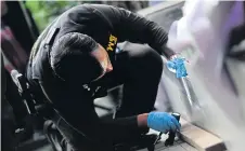  ??  ?? Forensic police examine the BTS Siam Square station, close to where two pipe bombs exploded last Monday.